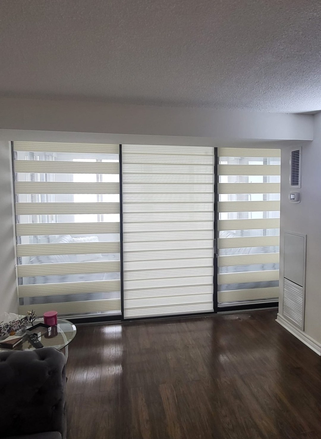 Blinds lowered to darken a Toronto condo living room